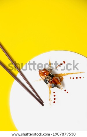 minimal food art with sushi with eel and nori. asian food concept. sushi art work abstraction with copy space over head. template for ads 
