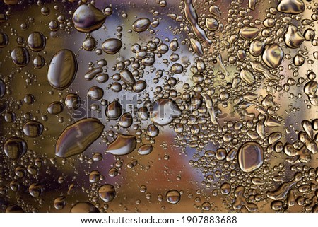 Oil on water and golden yellow background, texture