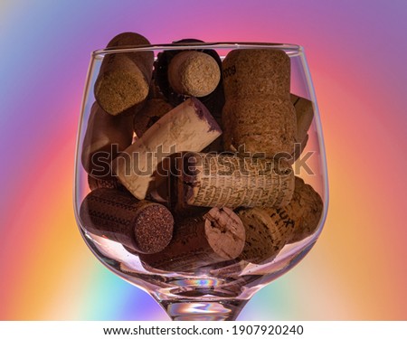 Large vine glass full of corks of the vine botles.
