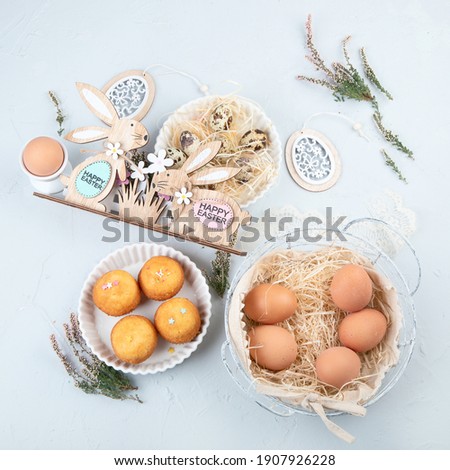 Easter composition with eggs and colorful sweets on light gray background. Seasonal holiday concept. 