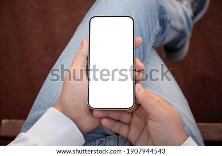 man in jeans holding gold phone with isolated screen 