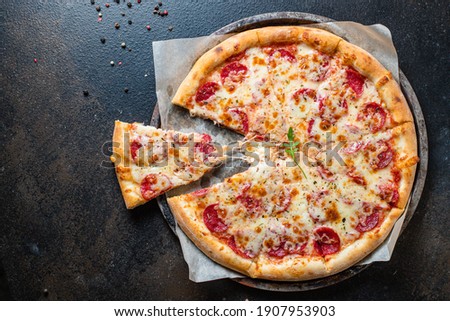 pizza pepperoni with meat sausage and double cheese fast food Takeaway ready to eat portion on the table for healthy meal snack outdoor top view copy space for text food background rustic image Royalty-Free Stock Photo #1907953903