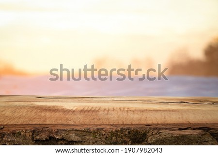 OLD WOODEN TABLE ON NATURAL BACKGROUND AT SUN SET LIGHT, BACKDROP BACKGROUND FOR MONTAGE OR DISPLAY PRODUCTS