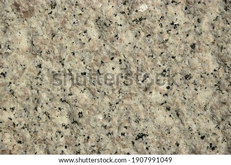 Rough gray stone surface with dark dots Royalty-Free Stock Photo #1907991049