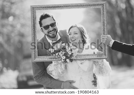 Black and white picture of happy wedding couple together. Groom and bride in frame.