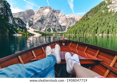 couple resting on boat at mountain lake. summer vacation Royalty-Free Stock Photo #1908047719