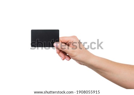 Business card in female hand, closeup isolated on white background. Close up of womans hand holding blank black card.