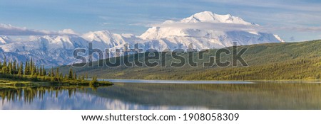 Denali, also referred to simply as "The Mountain", is the crown jewel of Denali National Park. As North America's highest peak it is an impressive sight not only in height but also sheer mass.  Royalty-Free Stock Photo #1908058309