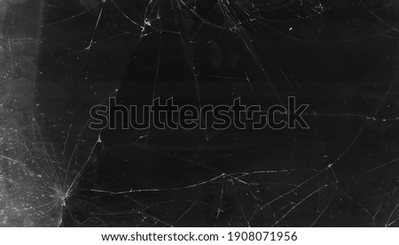 Cracked overlay. Broken glass texture. Black smashed distressed tablet screen with dust scratches fingerprints stains grain noise effect for photo editor. Royalty-Free Stock Photo #1908071956