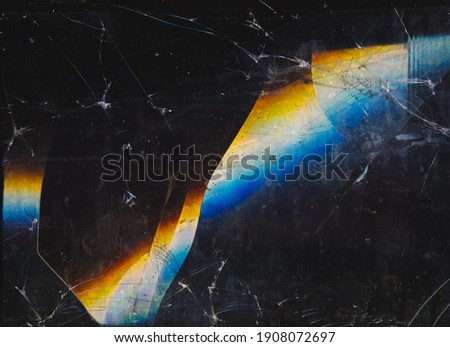 Fractured background. Blur lens flare. Dark shattered distressed dirty faded screen matrix texture with dust scratches smeared stains defocused orange blue white glow. Royalty-Free Stock Photo #1908072697