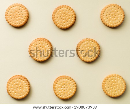 pattern from sandwich cookies, baked biscuits isolated on beige background, top view, flat lay
