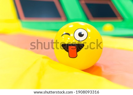 Yellow latex ball in the trampoline park playground zone. Colorful positive background.