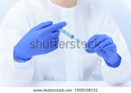 Doctor filling syringe with medication, closeup. Vaccination and immunization
