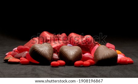 A pile of Valentine's day candy and chocolate with shallow depth of field
