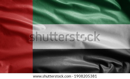 United Arab Emirates flag waving in the wind. Close up of UAE banner blowing, soft and smooth silk. Cloth fabric texture ensign background. Use it for national day and country occasions concept.