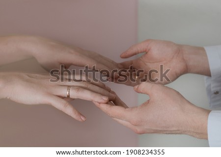                 close-up of the hands of a man and a woman on a light background               