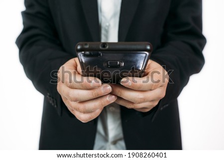 A closeup shot of a male holding a smartphone on a white background