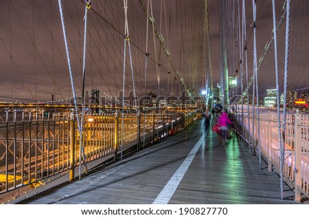 View of Brooklyn Bridge and Manhattan skyline by night