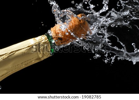 Close-up of explosion of champagne bottle cork with dark background