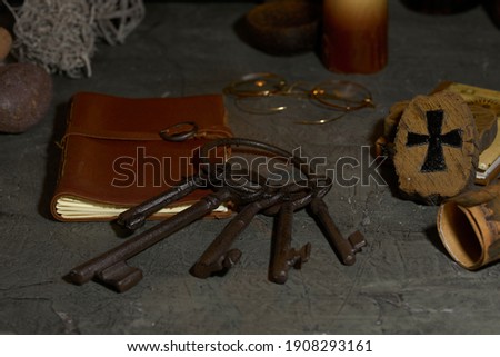 old keys on wooden table and rustic stone