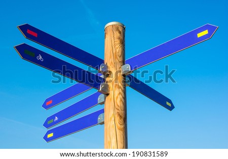 Wooden Pole With Numerous Direction Arrows