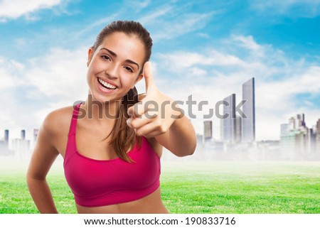 portrait of pretty sporty girl doing a positive gesture
