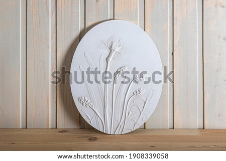 Stylish living room interior with botanical bas-relief wildflowers for wall art. 3D Flower plaster decor. Modern and luxury decoration in Scandinavian style.