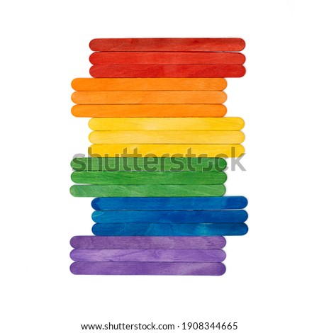 Rainbow color wooden ice cream sticks on white. Multicolored abstract  lgbt concept.