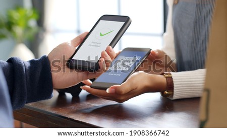 Customer using phone for payment at cafe restaurant, cashless QR code technology and money transfer concept Royalty-Free Stock Photo #1908366742
