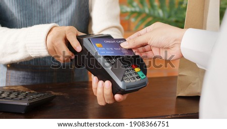 Customer using credit card for payment to owner at cafe restaurant, cashless technology and credit card payment concept Royalty-Free Stock Photo #1908366751