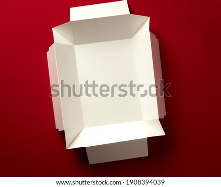 open box on red background. top view