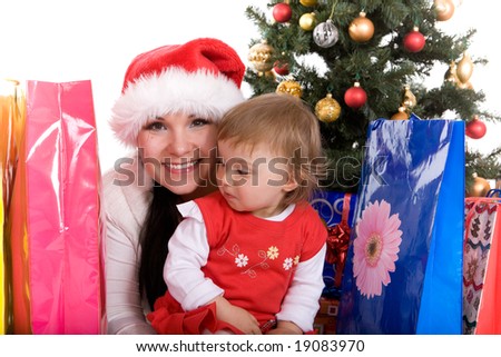 happy mother and daughter over christmas tree