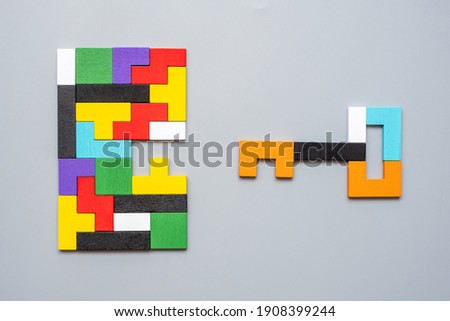 Key and keyhole shape of geometric colorful wood puzzle pieces. logical thinking, business logic, Conundrum, decision, solutions, rational, mission, success, goals and strategy concepts Royalty-Free Stock Photo #1908399244