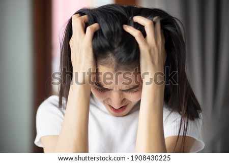 portrait of stressed sick asian woman with headache, depressed woman suffers from vertigo, dizziness, migraine, hangover, overwork, office syndrome depicting health care and mental health concept Royalty-Free Stock Photo #1908430225