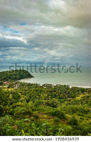 landscape serene view with sea horizon and dense green forests image is taken at om beach gokarna karnataka india from mountain top. it is showing the breathtaking view of gokarna.