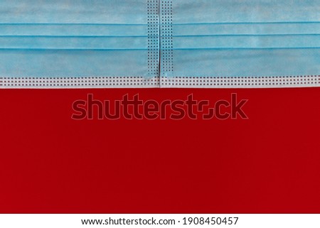 Two blue medical masks on a red background. The concept of Valentine's Day and coronavirus. Romantic holiday mockup. Love concept. 14th february
