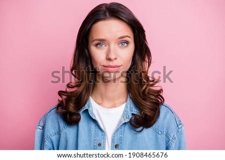 Photo of serious charming beautiful young lady wear denim jacket isolated on pastel pink color background
