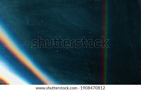 Scratched background. Lens flare effect. Blue distressed aged faded grunge surface with smeared stains dust noise colorful light design.