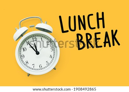  Lunch break time,Time for Lunch, Alarm clock on yellow background Royalty-Free Stock Photo #1908492865