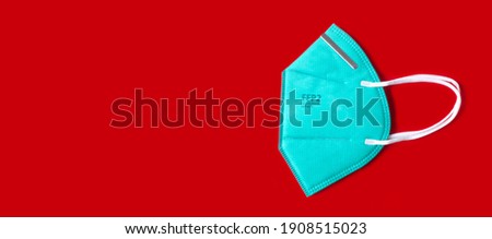 Side view of FFP 2 n95 protective face mask isolated on red background. Banner size, panorama, with copyspace for your individual text.