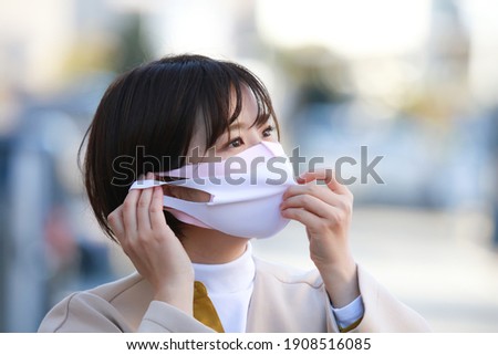 Image of a woman wearing a mask 
