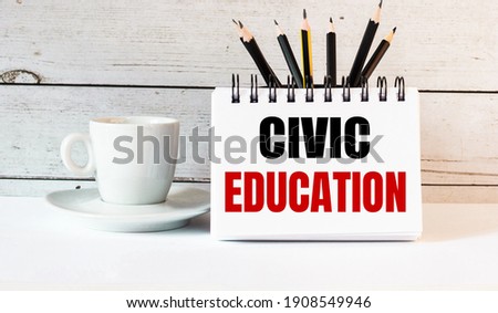 The word CIVIC EDUCATION is written in a white notepad near a white cup of coffee on a light background