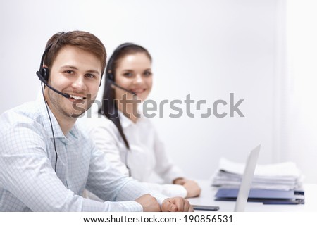 Attractive young people working in a call center