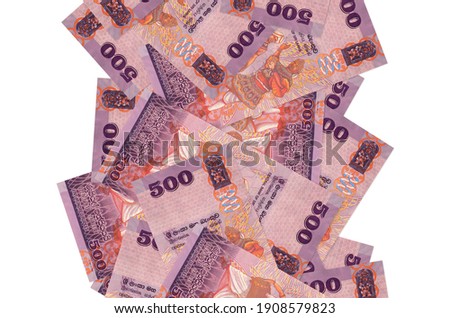 500 Sri Lankan rupees bills flying down isolated on white. Many banknotes falling with white copy space on left and right side