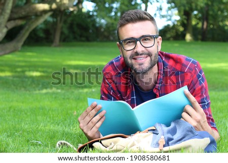 Adult student reading in the park