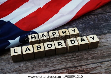 Happy Labor Day Word alphabet letters with USA flag on wooden background