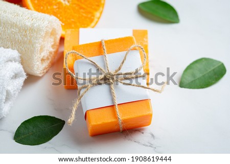 Orange soap with fresh orange on marble background