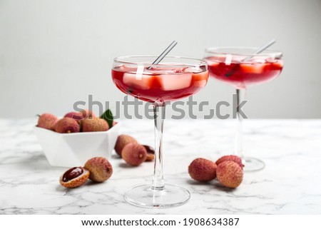 Delicious lychee cocktails and fresh fruits on white marble table