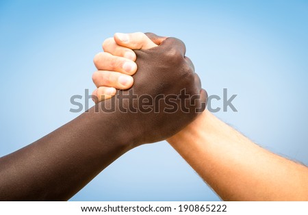Black and white human hands in a modern handshake to show each other friendship and respect - Arm wrestling against racism Royalty-Free Stock Photo #190865222
