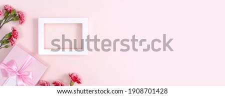 Concept of Mother's day holiday greeting background design  with carnations bouquet on pink background